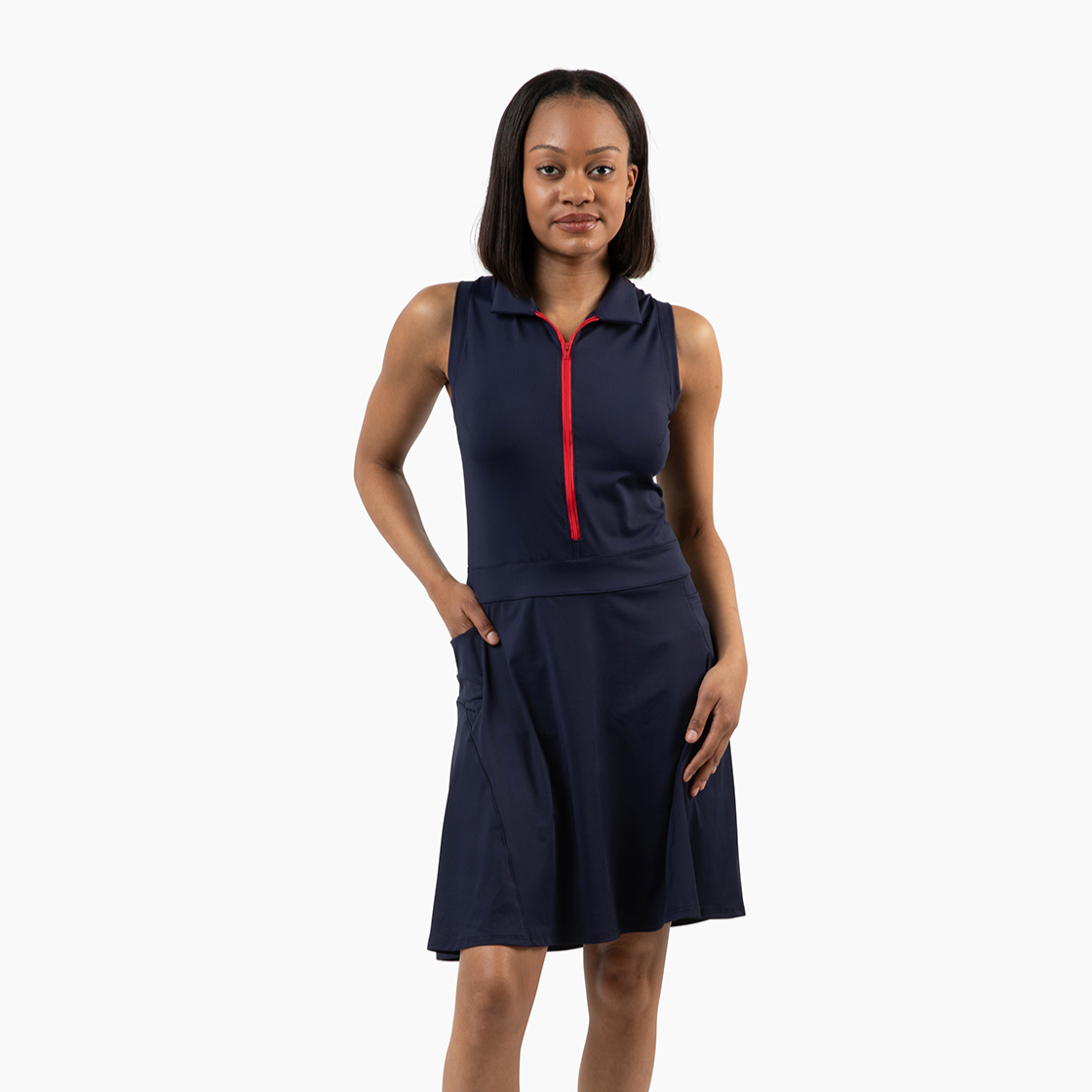 Woman wearing a navy sleeveless dress with a red zipper on a white background