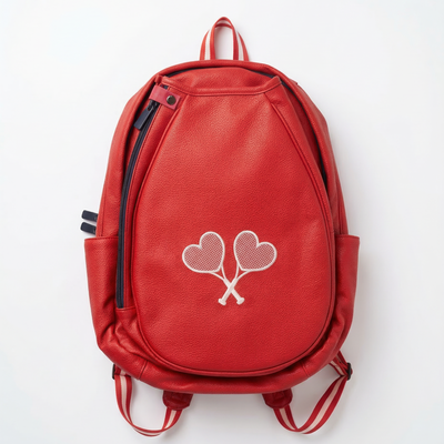 Red backpack with heart-shaped paddle design on a white background