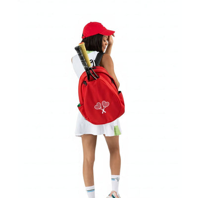 Person wearing a red backpack with tennis equipment on a white background
